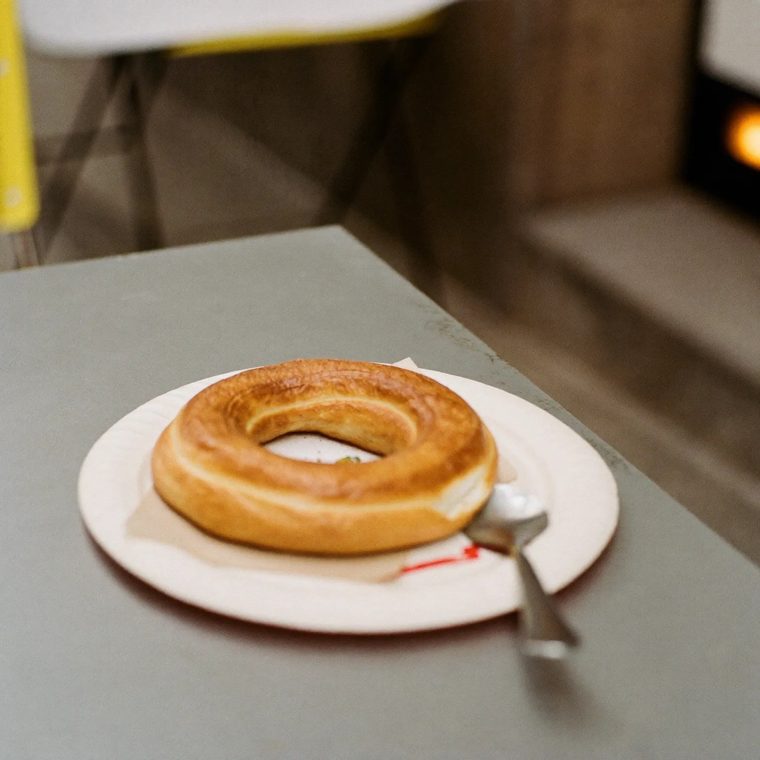A toasted teacake on a paper plate